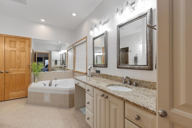 bathroom with tile patterned floors, recessed lighting, a bath, and vanity