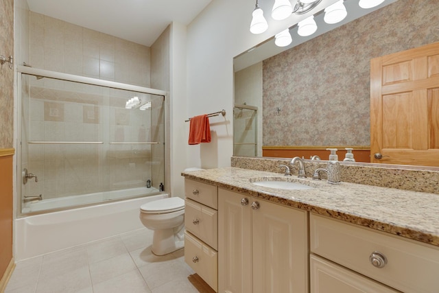 full bathroom with vanity, toilet, enclosed tub / shower combo, and tile patterned flooring