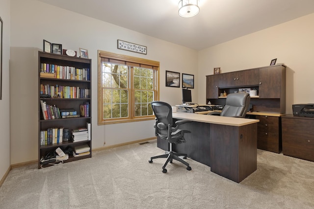 office area with light colored carpet and baseboards