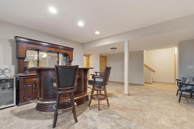 bar with recessed lighting, light tile patterned floors, bar, stairway, and wine cooler