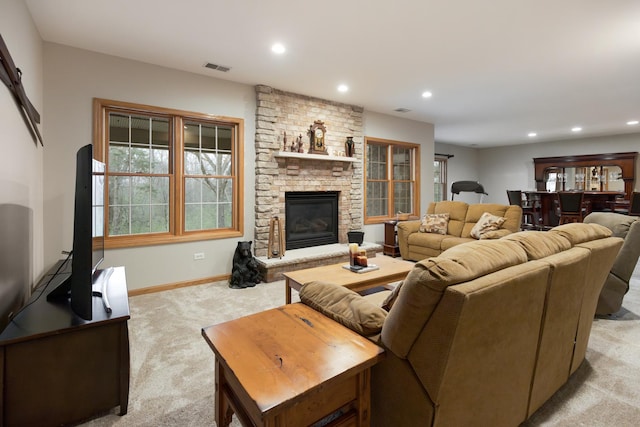 living area with recessed lighting, light colored carpet, a fireplace, baseboards, and visible vents