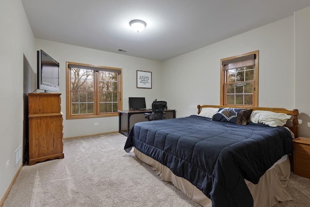 carpeted bedroom with multiple windows, baseboards, and visible vents