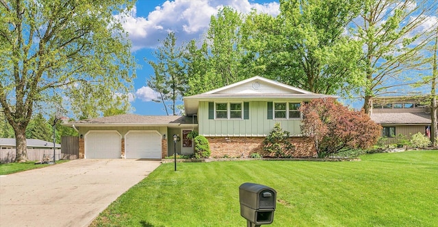tri-level home with a garage, a front lawn, brick siding, board and batten siding, and concrete driveway