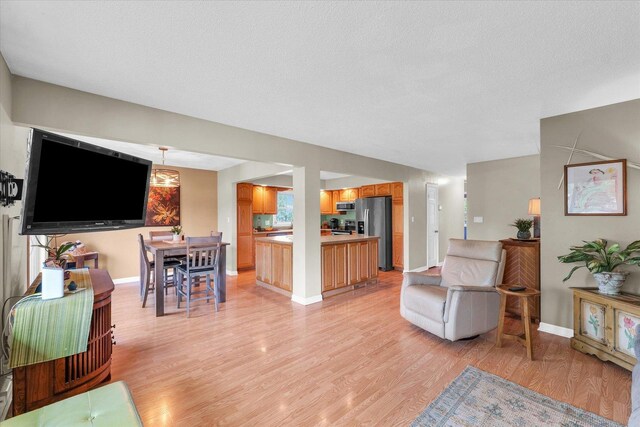 living room featuring light wood-style floors and baseboards
