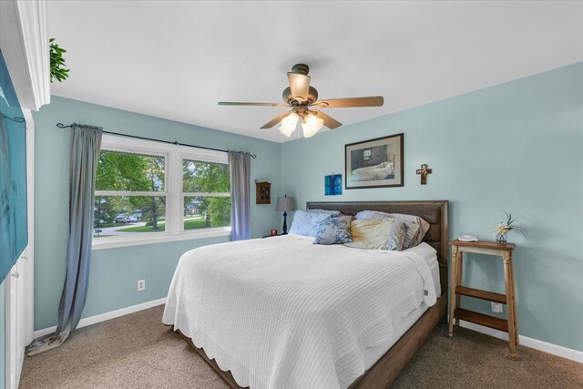 carpeted bedroom with baseboards and ceiling fan