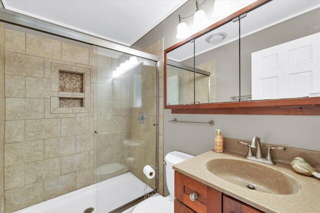full bath with vanity, a shower stall, and toilet