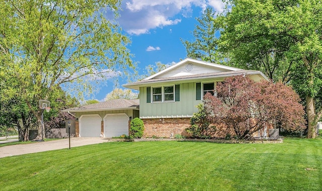 split level home with board and batten siding, brick siding, a front lawn, concrete driveway, and an attached garage