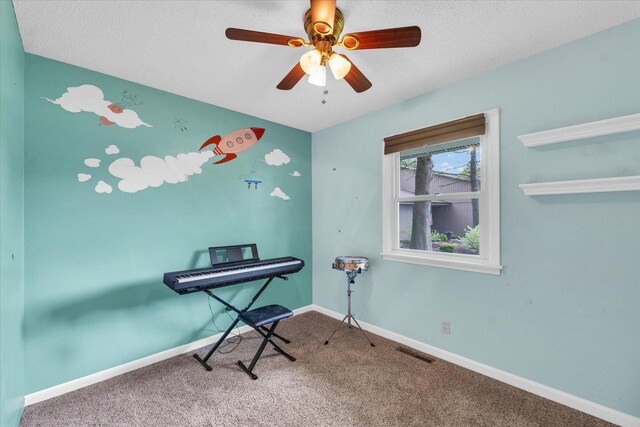 interior space with visible vents, carpet floors, baseboards, ceiling fan, and a textured ceiling