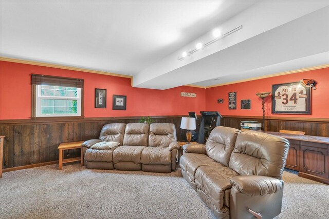 living area with crown molding, a wainscoted wall, carpet, and wood walls