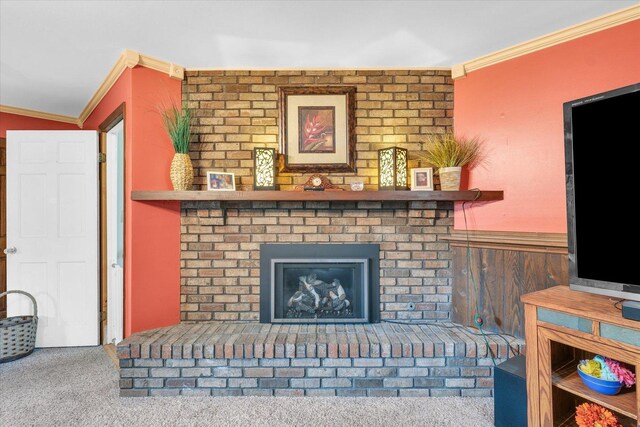 carpeted living area featuring crown molding and a fireplace