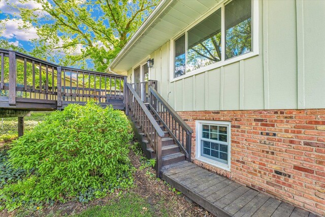 view of home's exterior featuring board and batten siding, stairway, and a wooden deck