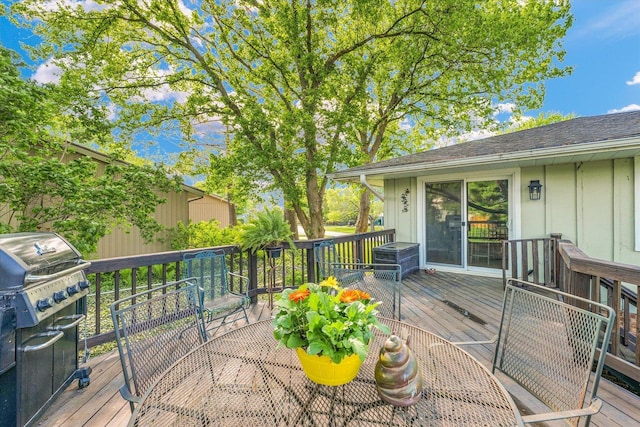 wooden terrace with grilling area and outdoor dining space