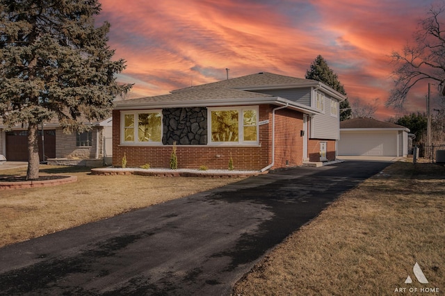10945 S Neenah Ave, Worth, IL 60482 - split level home featuring an outbuilding, a front lawn, a detached garage, brick siding, and a shingled roof