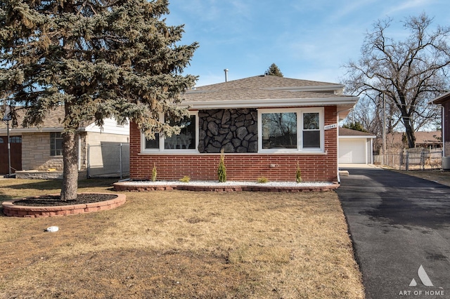 10945 S Neenah Ave, Worth, IL 60482 - view of front of property with fence, a shingled roof, a detached garage, brick siding, and a front yard