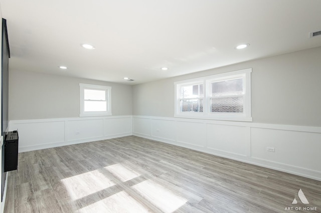 10945 S Neenah Ave, Worth, IL 60482 - spare room featuring a wainscoted wall, recessed lighting, a decorative wall, and light wood-style flooring