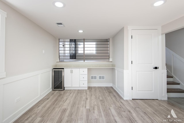 10945 S Neenah Ave, Worth, IL 60482 - bar with light wood-type flooring, a wainscoted wall, and visible vents