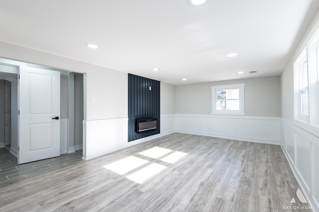10945 S Neenah Ave, Worth, IL 60482 - interior space featuring a wainscoted wall, a large fireplace, visible vents, and light wood-style floors