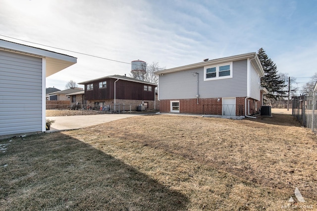 10945 S Neenah Ave, Worth, IL 60482 - rear view of property with central AC unit, fence, a yard, a patio, and brick siding