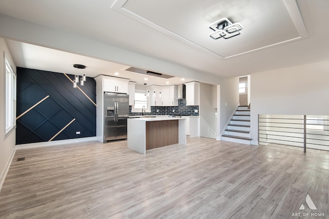 10945 S Neenah Ave, Worth, IL 60482 - kitchen featuring light wood-style flooring, stainless steel fridge, open floor plan, white cabinetry, and a kitchen island