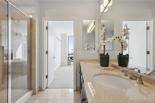 bathroom featuring a shower stall, a healthy amount of sunlight, and a sink