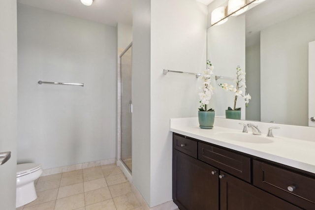 full bathroom with a shower stall, toilet, vanity, and baseboards