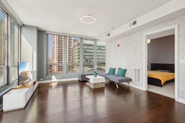 sitting room featuring baseboards, wood finished floors, and visible vents