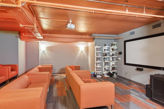 cinema with baseboards, wood finished floors, and visible vents