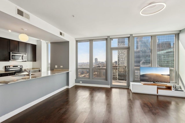 living room with baseboards, wood finished floors, and visible vents