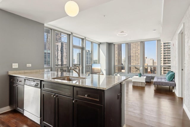 kitchen with dark wood-style floors, dishwasher, a sink, open floor plan, and a view of city