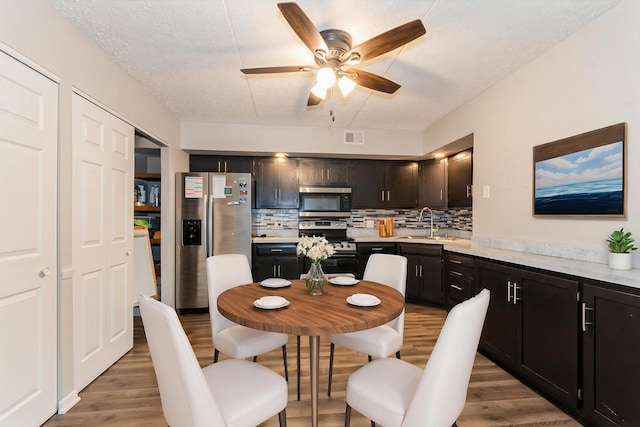 1472 N Rock Run Dr Unit 1C, Crest Hill, IL 60403 - dining room with ceiling fan, light wood-type flooring, and a textured ceiling