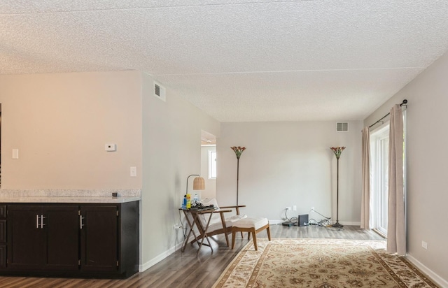 1472 N Rock Run Dr Unit 1C, Crest Hill, IL 60403 - kitchen featuring wood finished floors, a textured ceiling, light countertops, and baseboards