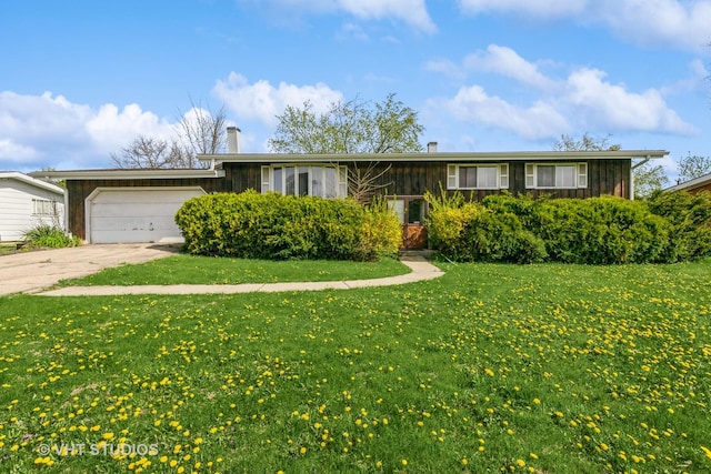 single story home featuring an attached garage, a front lawn, board and batten siding, a chimney, and driveway