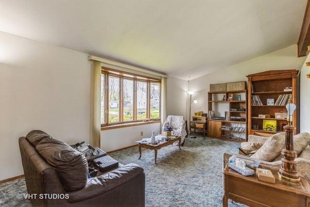 carpeted living area with baseboards and lofted ceiling