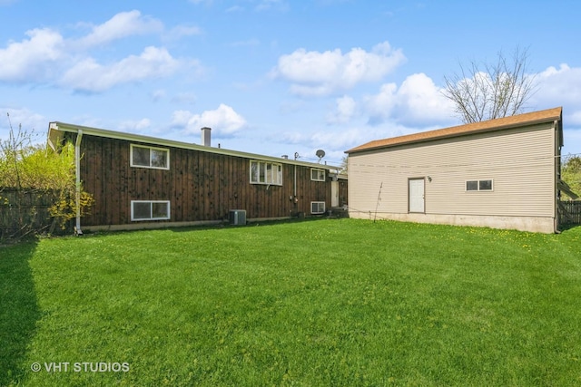 back of house featuring a yard, fence, and cooling unit