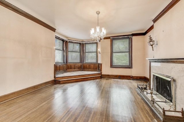 1312 N Astor St, Chicago, IL 60610 - unfurnished living room featuring a chandelier, ornamental molding, wood finished floors, a tiled fireplace, and baseboards