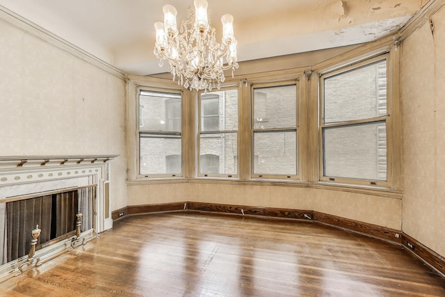 1312 N Astor St, Chicago, IL 60610 - unfurnished living room featuring wood finished floors, a chandelier, baseboards, and healthy amount of natural light