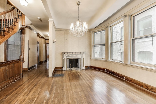 1312 N Astor St, Chicago, IL 60610 - unfurnished living room with hardwood / wood-style floors, a chandelier, a fireplace, and baseboards