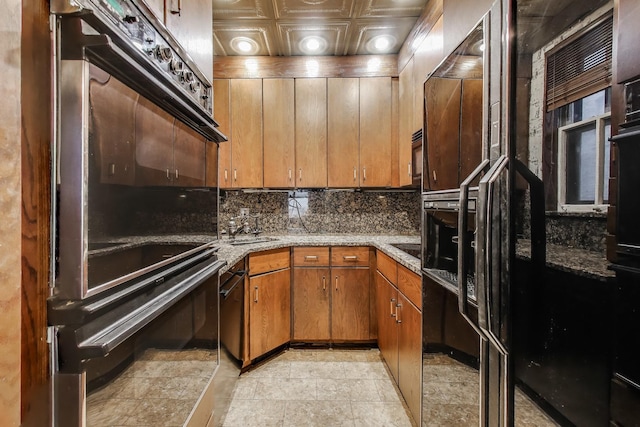 1312 N Astor St, Chicago, IL 60610 - kitchen with backsplash, an ornate ceiling, light stone counters, and brown cabinets