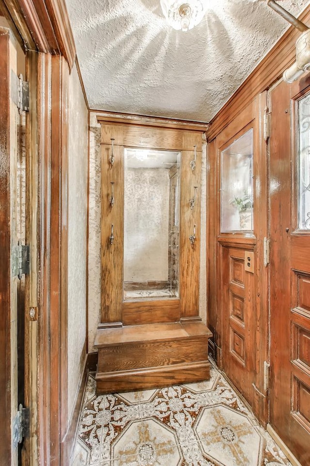 1312 N Astor St, Chicago, IL 60610 - hallway featuring crown molding, a textured ceiling, tile patterned flooring, and baseboards