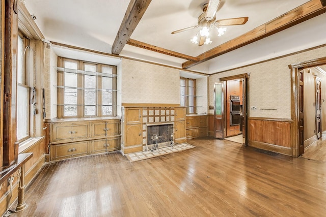 1312 N Astor St, Chicago, IL 60610 - unfurnished living room featuring wood finished floors, healthy amount of natural light, ceiling fan, beam ceiling, and a wainscoted wall