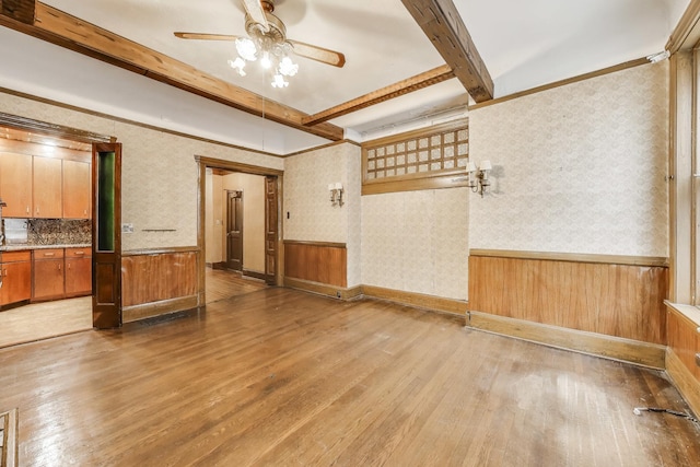 1312 N Astor St, Chicago, IL 60610 - unfurnished living room with hardwood / wood-style flooring, ceiling fan, beamed ceiling, a wainscoted wall, and wallpapered walls