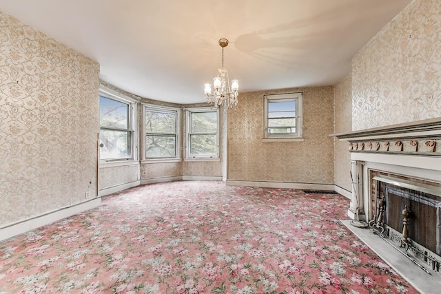 1312 N Astor St, Chicago, IL 60610 - unfurnished living room with a chandelier, a fireplace, carpet flooring, wallpapered walls, and baseboards