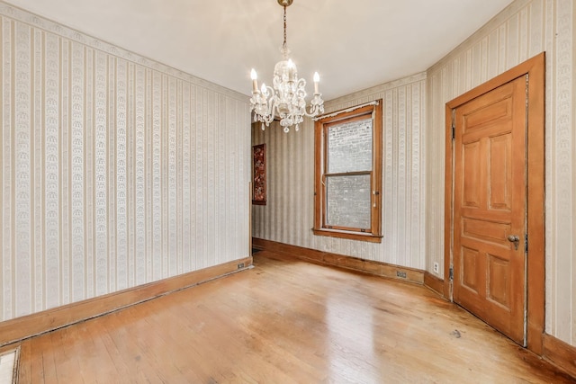 1312 N Astor St, Chicago, IL 60610 - empty room with wood finished floors, a chandelier, baseboards, and wallpapered walls
