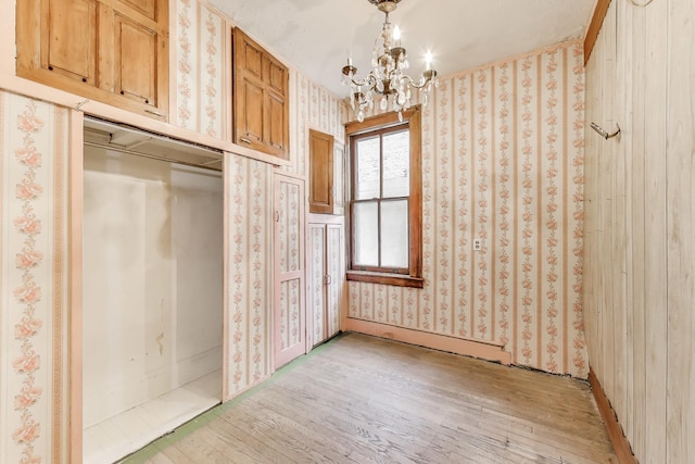 1312 N Astor St, Chicago, IL 60610 - unfurnished dining area with light wood finished floors, a chandelier, and wallpapered walls
