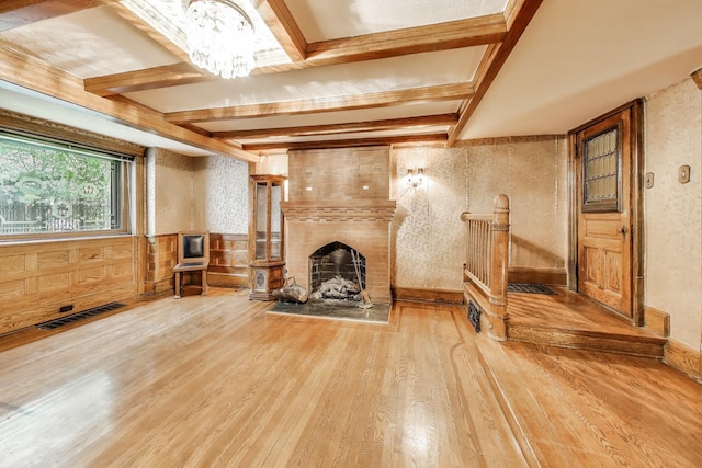 1312 N Astor St, Chicago, IL 60610 - living area with wood finished floors, a chandelier, a large fireplace, beamed ceiling, and a wainscoted wall