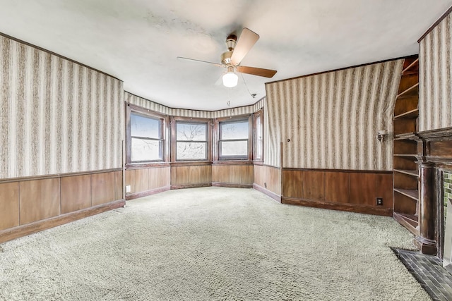 1312 N Astor St, Chicago, IL 60610 - spare room with a ceiling fan, carpet floors, a wainscoted wall, wallpapered walls, and wood walls