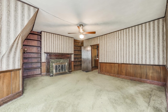 1312 N Astor St, Chicago, IL 60610 - unfurnished living room with wallpapered walls, a wainscoted wall, a ceiling fan, a fireplace, and carpet floors