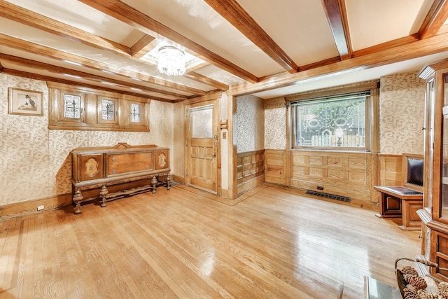 1312 N Astor St, Chicago, IL 60610 - living area with wallpapered walls, light wood-style floors, wainscoting, and beamed ceiling