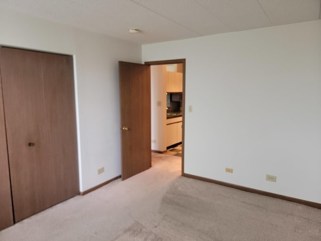 75 Kristin Cir Unit 401, Schaumburg, IL 60195 - unfurnished bedroom with light carpet, a closet, and baseboards
