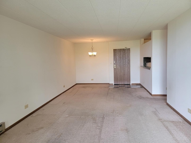 75 Kristin Cir Unit 401, Schaumburg, IL 60195 - carpeted empty room featuring a chandelier, baseboards, and a baseboard radiator